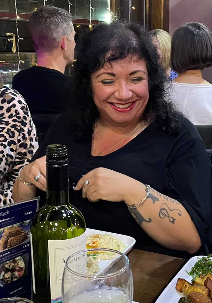 Samantha smiling at a group social event